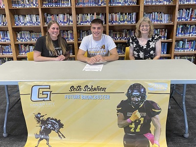 Victoria's Seth Schwien signs a National Letter of Intent to play Football at Garden City Community College on Tuesday, May 7, 2024. (Photo courtesy of Victoria Junior-Senior High School).