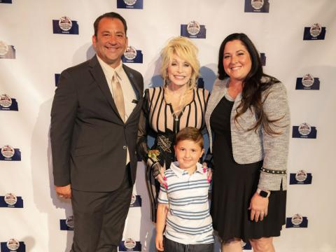 Rep. Troy Waymaster with his wife Crystal and son Christian along with Dolly Parton.
